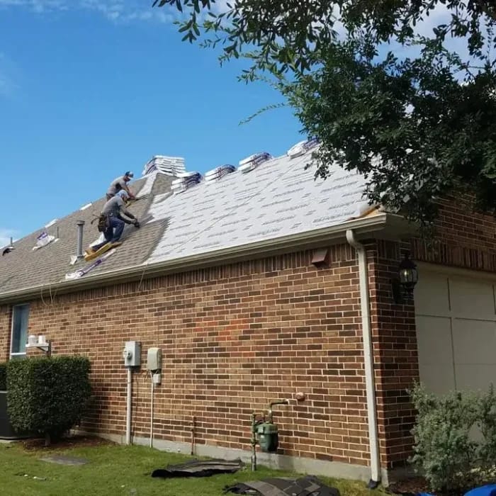 Montesco Roofing crew installing new shingles on residential home