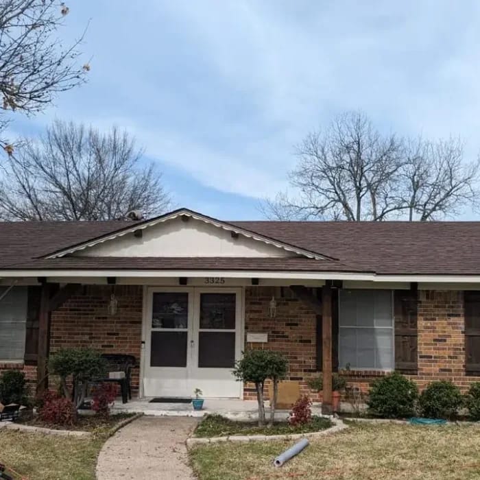 Residential roof replacement on brick home showing quality shingle installation